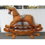 A 20th century laminated rocking horse, horsehair mane and tail, bridle, padded saddle,