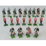 Twenty Britains and William Grant & Sons lead model figures of soldiers on parade including pipers.