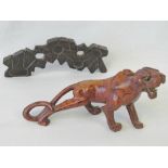 A carved and stylised depiction of a lion with glass eyes (19cm long, visible signs of repair,