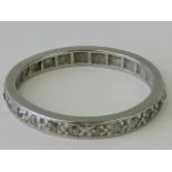 A platinum and diamond eternity ring,