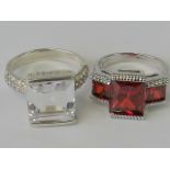 Two silver cocktail rings; one set with trio of graduated red stones, size N,