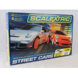 A boxes Scalextric 'Street Cars' set complete with 15ft track and two Porsche 997 race cars,