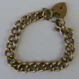 A 9ct gold heavy curb link charm bracelet with heart padlock clasp hallmarked 375, 29g.