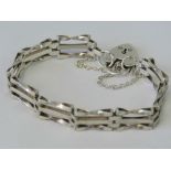 A HM silver three bar gate bracelet with heart padlock clasp, hallmarked Birmingham 1978.