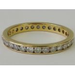 An 18ct gold and diamond eternity ring, thirty round brilliant cut diamonds totalling 1ct in weight,