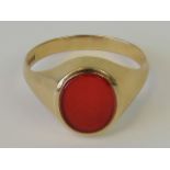 A 9ct gold signet ring with uncarved carnelian oval plaque, hallmarked 375, size Y, 4.