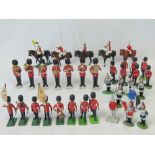 A collection of Britains plastic model British soldiers on dress parade together with some Corgi