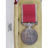 A British Empire medal with ribbon with presentation case.