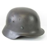 A WWII German Helmet complete with liner; stamped "NS64" to inner rim.