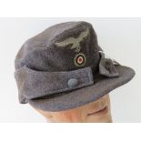 A WWII German Luftwaffe issue ski/peaked cap with cloth eagle.