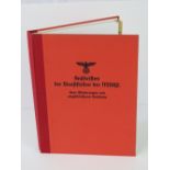 A reproduction German NASDAP party red organisation address book having facsimile pages within.