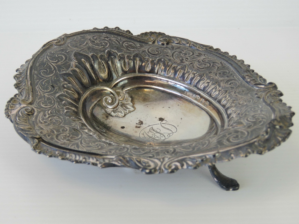 A Victorian HM silver repoussé three footed pin dish, Birmingham 1895, 2ozt, 14cm long.