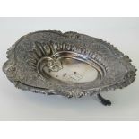 A Victorian HM silver repoussé three footed pin dish, Birmingham 1895, 2ozt, 14cm long.