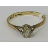 A 9ct gold and diamond solitaire ring, diamond illusion set on yellow metal shank hallmarked 375,