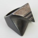 An abstract white metal and ebony ring, size N-O.