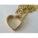 A yellow metal and diamond open heart pendant on yellow metal chain, 12.