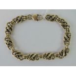 A heavy 9ct gold bracelet with infinity knot links, hallmarked 375, 23.5cm in length, 40.