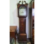 An eight day striking long case clock having painted arch top dial,