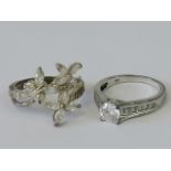 Two silver rings, one set with white stones in the form of two flowers and a butterfly, size Q-R,