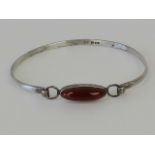 A HM silver bangle set with oval carnelian cabachon, hallmarked London 1974, 5.5 x 6.5 dia, 9.5g.