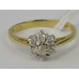 An 18ct gold diamond daisy cluster ring, seven round brilliant diamonds, total 0.