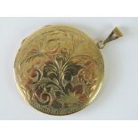 A large 9ct gold circular locket, engraved with floral design to front, hallmarked 375, 4cm dia, 13.