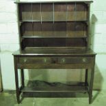 An unusual late 19th/early 20th century dresser having two-shelf solid-back rack over the base
