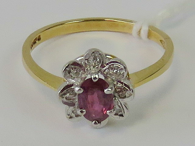 An 14ct gold ruby and diamond ring,