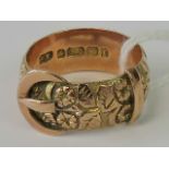 An unusual Victorian 9ct gold ring in the style of a belt and buckle, heavy floral engraving,