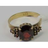 A 9ct gold and garnet ring,