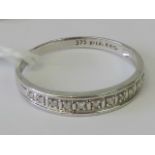 A 9ct white gold and diamond half eternity ring,