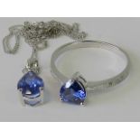 A 10ct white gold ring and necklace suite; ring with heart shaped blue stone,