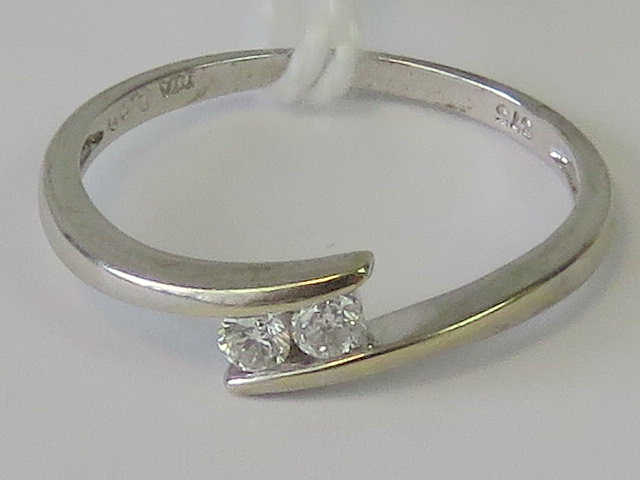 A 9ct white gold and diamond ring, pair of round cut brilliant diamonds,