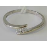 A 9ct white gold and diamond ring, pair of round cut brilliant diamonds,