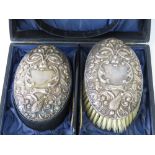 A pair of HM silver brushes within original fitted case, repoussé scrolling vines,