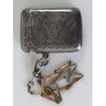 A HM silver vesta case, Birmingham 1906, with attached white and rose metal chain, total weight 0.