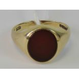 A 9ct gold signet ring set with oval uncarved bloodstone, hallmarked 375, size M, 4g.