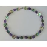 An amethyst and abalone shell necklace with silver clasp, stamped 925, 45cm long.
