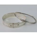 Two silver bangles; one stamped Sterling Germany with 'X design,