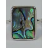 A silver ring set with rectangular abalone shell panel, stamped 925, size T.