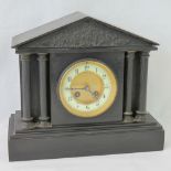 A Victorian polished slate architectural eight day striking mantle clock,
