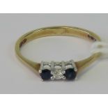 A 9ct gold diamond and sapphire ring, central diamond flanked by two sapphires,