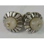 A pair of diamond and white quartz earrings, central white quartz sphere set with a single diamond,