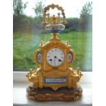 A highly ornate gilt brass Japy Frères mantel clock having hand painted ceramic decorative panels