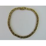 A 9ct gold fancy link bracelet with tongue clasp, hallmarked 375, 19cm long, 11.7g.