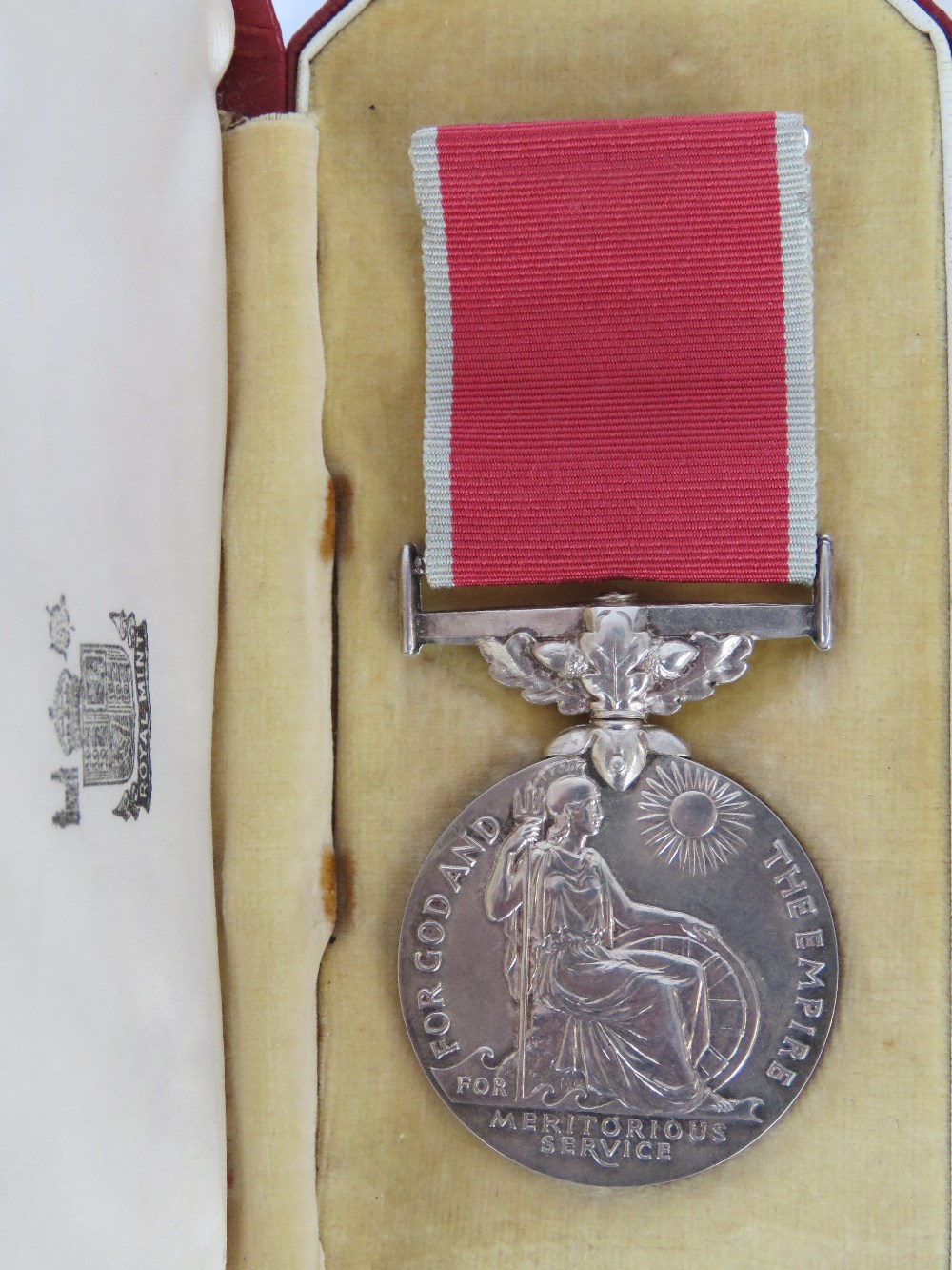 A British Empire medal with ribbon, stam