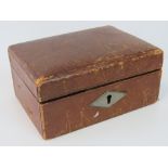 A vintage leather jewellery box, silk li