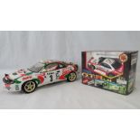 A Tamiya remote control Toyota Monte carlo rally car (without controller and engine) together with