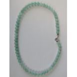 A green jade bead necklace with silver clasp, stamped 925, 51cm long, 46.