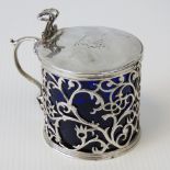 A HM silver pierced and lidded conserve pot with Bristol blue glass liner.